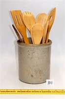 Ceramic crock w/ wooden kitchen tools; has a