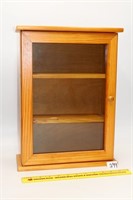 Wooden display case with glass door