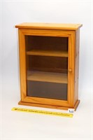 Wooden display case with glass door