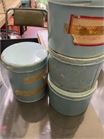 4 blue canisters, 1 metal lunchbox with leather