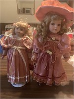 2 porcelain dolls in mauve dresses