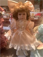 2 porcelain dolls (one in peach dress and one