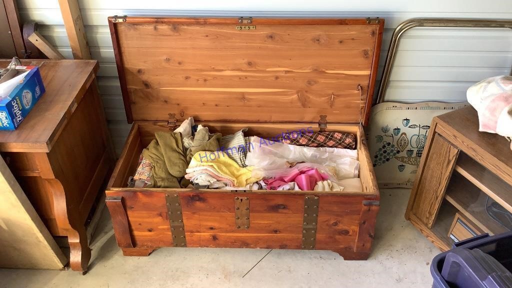 Cedar chest full of table cloths & towel