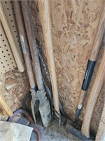 Long handled tools in shed. Shovels, post hole