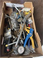 Box full of miscellaneous tools. Tire gauges,
