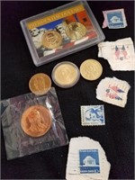 Group of presidential dollars and stamps with a