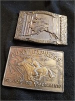 Two belt buckles 3.5 in one is Alaska the other