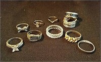 Group of rings one is Marked 925, one has a Bible