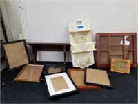 Group of picture frames with two wall shelves