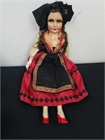 Antique doll has wooden legs and a cloth or paper