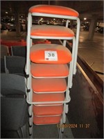 8 Orange vinyl upholstered stools, steel framed