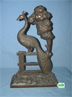 Large bronze peacock seated on fence door stop