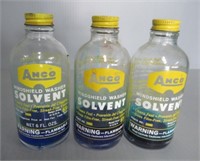 (3) Anco windshield washer bottles.
