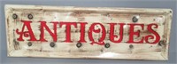 Tin Antiques sign. Measures: 11.5" H x 35" W.