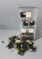 Plastic jewelry display with pierced earrings.