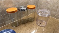 3 glass canisters and 1 plastic
