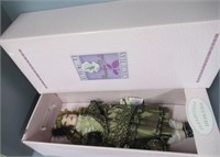 Porcelain doll in box by Collectable Memories.