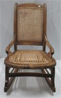 Vintage wood cane seat and back rocking chair.