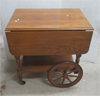 Tea cart on casters with pull out tray.