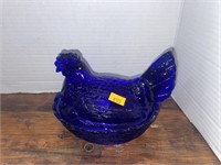 Cobalt blue chicken on a nest