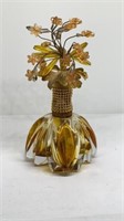 Perfume bottle with floral topper