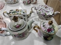 4 small teapots