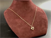 14kt Gold and diamond pendant in the shape of a he