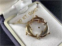 10kt Gold necklace, pendant is 3 dolphins in circl
