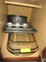 Casserole dishes and baking pans in cabinet