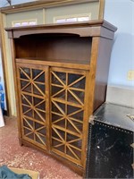 cherry stained curio cabinet with sliding doors