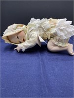 Laying on stomach porcelain baby doll