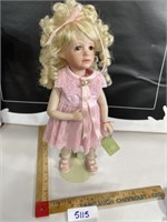 Porcelain doll pink dress blonde curly hair