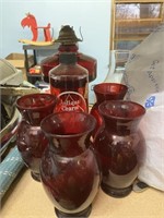 red kerosene lamp , bottle of lamp oil and 4 red