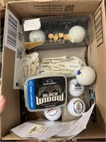 box of golf balls and golf tees