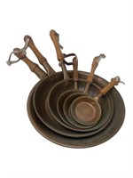 Copper pan grouping with wooden handles