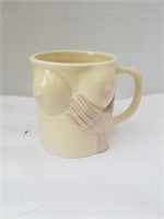 hand cupping breast coffee mug