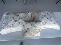 Two quilted pillow covers and pillows and quilted