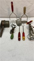 Red and green kitchen utensils, potato masher