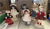 Misc lot of plastic and porcelain dolls w/stands