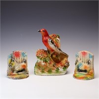 A pair of vintage chalkware bookends and a bird ch