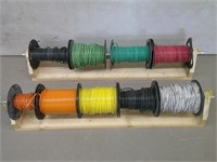 9 partial spools wire on two racks
