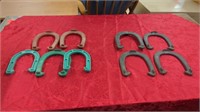 5 COLORED PLASTIC HORSESHOES AND 4 ROYAL CAST