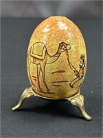 Egg on brass stand.