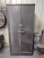 Metal two-door storage cabinet with contents,