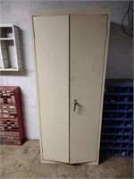 Two door metal storage cabinet with contents,