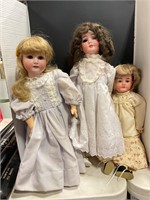 Three Porcelain dolls with accessories.