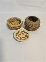Three tiny hand woven baskets