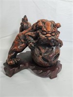 Carved Foo dog on wooden stand