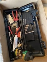 Case with pliers, drill bits, grease, wrenches