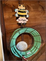 Water hose and reel, stepping stone and yard art
